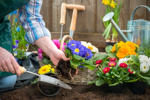 Team member planting vibrant flowers in Notting Hill garden
